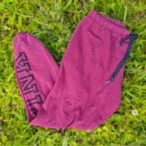 Victoria’s Secret sweatpants with black stripes and pink graphic